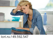 beautiful woman is tired of ironing every day. Стоковое фото, агентство Ingram Publishing / Фотобанк Лори