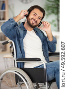 disabled man wearing headset and listening to music. Стоковое фото, агентство Ingram Publishing / Фотобанк Лори