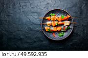 Kebabs from dried and salmon on wooden skewers.Salted salmon slices. Dried fish salmon. Стоковое фото, агентство Ingram Publishing / Фотобанк Лори