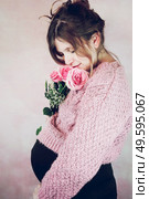 Young pregnant woman holding a bouquet of roses. Стоковое фото, агентство Ingram Publishing / Фотобанк Лори