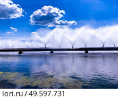 Colorful sight: cooling fountains of the Atomic Station, Heat of a power plant against a background of white clouds and blue sky.. Colorful sight: cooling fountains of the Atomic Station, Heat of a power plant against a background of white clouds, blue sky. Стоковое фото, агентство Ingram Publishing / Фотобанк Лори
