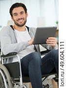 happy freelancer in the wheelchair holding a tablet. Стоковое фото, агентство Ingram Publishing / Фотобанк Лори