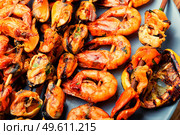 Kebab shrimps fried on a wooden stick.Grilled scampi. Grilled seafood on a skewer,close up. Стоковое фото, агентство Ingram Publishing / Фотобанк Лори