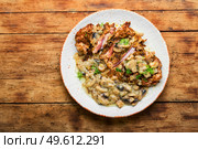 Turkey meat in cheese breading with mushroom sauce.Turkey schnitzel on rustic wooden table. Turkey steak with fried mushrooms. Стоковое фото, агентство Ingram Publishing / Фотобанк Лори