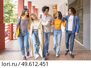 Multi-ethnic group of friends walking together on the street while chatting and having fun.. Multi-ethnic group of friends walking together on the street. Стоковое фото, агентство Ingram Publishing / Фотобанк Лори