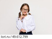 Negative human emotions, reactions and feelings. Isolated shot of moody displeased angry little girl poses with finger on cheek in a thinking expression, having offended facial expression. Стоковое фото, фотограф Ирина Михайличенко / Фотобанк Лори