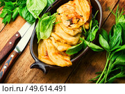 Pie stuffed with spring greens and cheese. Homemade qutabs or kutab. Azeyrbajan food. Tasty qutab with young greens on wooden table. Стоковое фото, агентство Ingram Publishing / Фотобанк Лори