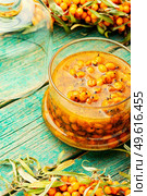 Healthy sea buckthorn jam. Homemade berry jam on wooden surface. Autumn sea buckthorn jam. Стоковое фото, агентство Ingram Publishing / Фотобанк Лори