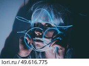 Weird dystopian theme portrait with blue neon lights. Стоковое фото, агентство Ingram Publishing / Фотобанк Лори