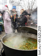 meat soup with herbs and spices boils over the fire in a large saucepan. Стоковое фото, агентство Ingram Publishing / Фотобанк Лори