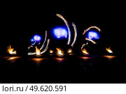 fiery pieces of a fire show against a dark sky and thunderstorms. Стоковое фото, агентство Ingram Publishing / Фотобанк Лори