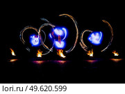 fiery pieces of a fire show against a dark sky and thunderstorms. Стоковое фото, агентство Ingram Publishing / Фотобанк Лори