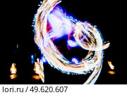 fiery pieces of a fire show against a dark sky and thunderstorms. Стоковое фото, агентство Ingram Publishing / Фотобанк Лори