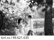 guy and a girl walk along the paths of a forest park between tall trees. Стоковое фото, агентство Ingram Publishing / Фотобанк Лори