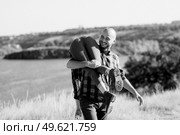 Guy and girl in caged shirts and trekking shoes on granite rocks. Стоковое фото, агентство Ingram Publishing / Фотобанк Лори