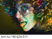 Young woman portrait illuminated by psychedelic lights. Стоковое фото, агентство Ingram Publishing / Фотобанк Лори