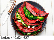 Beetroot pancakes with feta cheese, broccoli and cucumber.. Pancakes from beetroot,healthy food. Стоковое фото, агентство Ingram Publishing / Фотобанк Лори