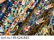 Kyoto, Japan - November 09, 2018: Close-up of kimono material for sale in a market in Kyoto city, Japan. Kimono textiles can to be classified into two categories: Gofuku, which indicates silk textiles in general, for luxuries and cotton-hemp Futomono for everyday wear.. Close-up of kimono material for sale in a market in Kyoto city, Japan. Редакционное фото, агентство Ingram Publishing / Фотобанк Лори