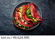 Delicious beetroot pancakes with broccoli and cucumber on a slate background. Vegetarian food. Pancakes from beetroot, vegetable flapjack. Стоковое фото, агентство Ingram Publishing / Фотобанк Лори