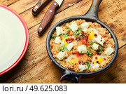 Israeli shakshuka made from fried eggs, tomato, minced lamb and hot spices.. Israeli shakshuka,scrambled eggs. Стоковое фото, агентство Ingram Publishing / Фотобанк Лори