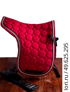red professional  dressage saddle cloth with  girth  against white background. equestrian concept. Стоковое фото, агентство Ingram Publishing / Фотобанк Лори