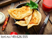 Cheburek, a dish of unleavened dough stuffed with minced meat. Crimean Tatar cuisine. Fried pies with meat filling. Стоковое фото, агентство Ingram Publishing / Фотобанк Лори
