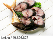 Fragrant tuna mackerel smoked in spices. Pieces of salted scomber. Delicious smoke-dried mackerel. Стоковое фото, агентство Ingram Publishing / Фотобанк Лори