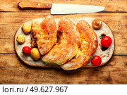 Closed pizza with mushrooms. Calzone - Italian pie. Calzone - Italian pie, pizza. Стоковое фото, агентство Ingram Publishing / Фотобанк Лори