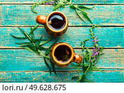 Cup of herbal tea on the table. Ivan tea or fireweed.Willow-herb. Aromatic fireweed tea. Стоковое фото, агентство Ingram Publishing / Фотобанк Лори
