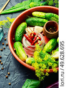 Salted homemade cucumbers.Cooking process.Canned gherkin.Marinated vegetable.Preparation for pickling cucumbers. Fresh cucumbers and ingredients for cooking pickled cucumbers. Стоковое фото, агентство Ingram Publishing / Фотобанк Лори