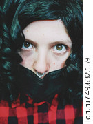 Young woman wearing a black face mask. Стоковое фото, агентство Ingram Publishing / Фотобанк Лори