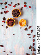  jerked cherry with   dry dog rose and hawthorn,  anise  around blue wooden background . Christmas background. flat lay. Стоковое фото, агентство Ingram Publishing / Фотобанк Лори