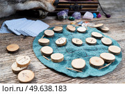 Handmade runes for fortunetelling over leather chart. Handmade runes for fortunetelling. Стоковое фото, агентство Ingram Publishing / Фотобанк Лори