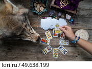 Fortune telling on tarot cards, witch hand is opening cards, used Marseille Tarot deck by unknown artist published first in 1709. Fortune telling on tarot cards. Стоковое фото, агентство Ingram Publishing / Фотобанк Лори