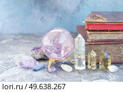 Gemstones set for relax and meditation. Magic ball and semipresious minerals for Reiki life balance with books in background, healing Crystal Ritual, Witchcraft, spiritual esoteric practice.. Healing crystals concept. Стоковое фото, агентство Ingram Publishing / Фотобанк Лори