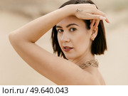 girl in a black long dress in a sandy desert under a blue sky. Стоковое фото, агентство Ingram Publishing / Фотобанк Лори