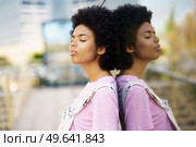 Thoughtful African-American woman with her eyes closed in a relaxed attitude on an urban background.. Thoughtful African-American woman with her eyes closed. Стоковое фото, агентство Ingram Publishing / Фотобанк Лори