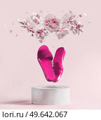 Pink flying flat sandal shoes at white podium with levitating peony flowers and petals at pink pastel background. Creative summer fashion concept with slippers and blossom. Modern product presentation. Стоковое фото, агентство Ingram Publishing / Фотобанк Лори