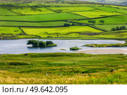view from the cliff Fair Head on Lough na Cranagh and island Crannagh, County Antrim, Northern Ireland, UK. view from the cliff Fair Head, Northern Ireland, UK. Стоковое фото, агентство Ingram Publishing / Фотобанк Лори