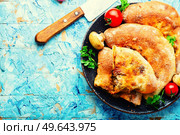 Closed pizza with mushrooms. Calzone - Italian pie. Copy space. Calzone - Italian pie, pizza. Стоковое фото, агентство Ingram Publishing / Фотобанк Лори