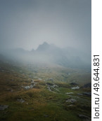 Transfagarasan mountain peak seen through the dense fog. Rainy scene in the mounts, hiking in the mist. Стоковое фото, агентство Ingram Publishing / Фотобанк Лори