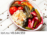Set of pickles from tomato, sauerkraut, okra, cucumbers and cowpea. Pickles. Tasty homemade pickles, preserved. Стоковое фото, агентство Ingram Publishing / Фотобанк Лори