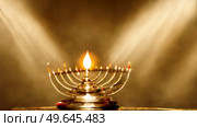 Menorah for Hanukkah holiday over golden background. Menorah for Hanukkah holiday. Стоковое фото, агентство Ingram Publishing / Фотобанк Лори