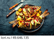 Yummy fried whole fish in fruit marinade. Fragrant roasted fish. Стоковое фото, агентство Ingram Publishing / Фотобанк Лори