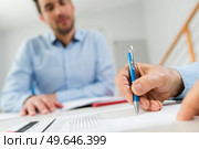 close up of hands signing official document. Стоковое фото, агентство Ingram Publishing / Фотобанк Лори