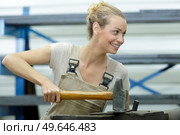 female worker using hammer over anvil. Стоковое фото, агентство Ingram Publishing / Фотобанк Лори