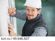 white safely helmet male engineer with blue print. Стоковое фото, агентство Ingram Publishing / Фотобанк Лори