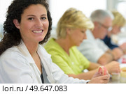young female dental technician posing and smiling. Стоковое фото, агентство Ingram Publishing / Фотобанк Лори