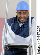 black worker is looking at the camera and squinting. Стоковое фото, агентство Ingram Publishing / Фотобанк Лори
