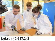 Students wearing masks using dremel. Стоковое фото, агентство Ingram Publishing / Фотобанк Лори
